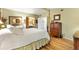 Well-lit bedroom with a four poster bed and ensuite bathroom access at 1639 W Schwartz Blvd, The Villages, FL 32159