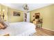Cozy bedroom featuring vintage decor, a comfortable bed and wood-look flooring at 1639 W Schwartz Blvd, The Villages, FL 32159