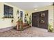 Inviting covered entryway showcasing plants, brick accents, and double doors at 1639 W Schwartz Blvd, The Villages, FL 32159