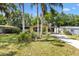 Well-maintained front yard with palm trees and other plants and shrubbery at 1639 W Schwartz Blvd, The Villages, FL 32159