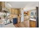 Well lit kitchen offers modern appliances, laminate floors, and wood cabinets at 1639 W Schwartz Blvd, The Villages, FL 32159
