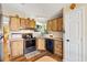 Bright kitchen featuring modern appliances, laminate floors, and wood cabinets at 1639 W Schwartz Blvd, The Villages, FL 32159
