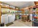 This laundry room has a washer and dryer and shelving for storage at 1639 W Schwartz Blvd, The Villages, FL 32159
