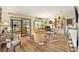 Bright living room boasts wood floors, sliding glass doors, and vintage decor at 1639 W Schwartz Blvd, The Villages, FL 32159