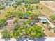 Aerial view of the property with lush surroundings and neighboring properties on a sunny day at 16724 Highland Ave, Montverde, FL 34756