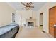 Neutral bedroom with a ceiling fan, brick fireplace, and doorway to another room at 16724 Highland Ave, Montverde, FL 34756