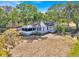 Exterior shot of a charming home with a screened in porch and mature trees at 16724 Highland Ave, Montverde, FL 34756