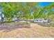 View of home with mature trees, showcasing proximity to additional structures on the property at 16724 Highland Ave, Montverde, FL 34756