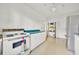 Kitchen with vintage appliances, white cabinets, and turquoise counter tops at 16724 Highland Ave, Montverde, FL 34756