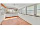 Enclosed sun room offers a tranquil space with multiple windows and wood floors at 16724 Highland Ave, Montverde, FL 34756