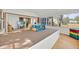 Sunroom with carpeted platform and many large windows, including a view of a television in the other room at 16724 Highland Ave, Montverde, FL 34756