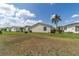 Spacious lawn and palm tree at 1706 Moreno Pl, The Villages, FL 32159