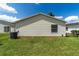 Back exterior of home features vinyl siding and a manicured yard at 1706 Moreno Pl, The Villages, FL 32159