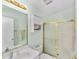 Bathroom with glass shower doors, vanity, and wall storage at 1706 Moreno Pl, The Villages, FL 32159