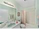 Bathroom features colorful shower curtain and lots of counter space at 1706 Moreno Pl, The Villages, FL 32159