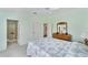 Bright bedroom features ensuite bathroom, ceiling fan, and neutral carpet at 1706 Moreno Pl, The Villages, FL 32159