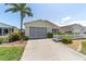 Lovely home with a screened garage and a paved driveway leading to the entrance at 1706 Moreno Pl, The Villages, FL 32159