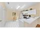 Bright kitchen with white cabinets, breakfast nook, and tile flooring at 1706 Moreno Pl, The Villages, FL 32159