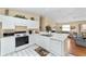 Fully equipped kitchen with white appliances, ample countertop space, and tile floors at 1706 Moreno Pl, The Villages, FL 32159