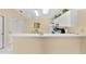 Functional kitchen with white cabinetry and breakfast bar, perfect for casual dining at 1706 Moreno Pl, The Villages, FL 32159