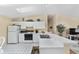 Modern kitchen design with white cabinets, stainless steel sink, and tile flooring at 1706 Moreno Pl, The Villages, FL 32159