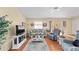 Cozy living room features hardwood floors, comfortable seating, and sliding glass door at 1706 Moreno Pl, The Villages, FL 32159