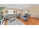 Bright living room features hardwood floors, comfortable seating, and a ceiling fan at 1706 Moreno Pl, The Villages, FL 32159
