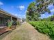 A beautiful backyard with greenery on a sunny day at 1741 Pennecamp Dr, The Villages, FL 32162