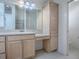 Bathroom features light wood vanity with granite counters and a large mirror at 1741 Pennecamp Dr, The Villages, FL 32162