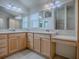 Primary bathroom featuring double sink vanity with light wood cabinets and tile floor at 1741 Pennecamp Dr, The Villages, FL 32162