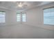 Spacious bright bedroom with tray ceiling and large windows with blinds at 1741 Pennecamp Dr, The Villages, FL 32162
