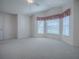 Bedroom featuring a vaulted ceiling and a large bay window at 1741 Pennecamp Dr, The Villages, FL 32162