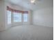 Bedroom showcasing vaulted ceilings and a large window for natural light at 1741 Pennecamp Dr, The Villages, FL 32162