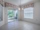 A bright dining room featuring access to the screened in patio with tile flooring at 1741 Pennecamp Dr, The Villages, FL 32162