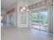 The bright dining room with tile flooring, sliding glass door, and backyard views at 1741 Pennecamp Dr, The Villages, FL 32162