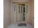 Open front door with decorative glass and side lites at 1741 Pennecamp Dr, The Villages, FL 32162