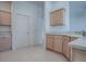 Open concept kitchen featuring light wood cabinets and neutral countertops at 1741 Pennecamp Dr, The Villages, FL 32162