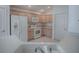 Bright kitchen showcasing white appliances and light wood cabinets with tile floors at 1741 Pennecamp Dr, The Villages, FL 32162
