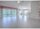 Bright living room featuring tile floors, white walls, sliding glass doors and views to other rooms at 1741 Pennecamp Dr, The Villages, FL 32162