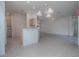 A spacious living room with open floorplan with tile flooring and kitchen view at 1741 Pennecamp Dr, The Villages, FL 32162
