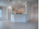 The bright living room features an adjacent kitchen area with white countertops at 1741 Pennecamp Dr, The Villages, FL 32162