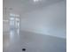A bright and airy living room features tile floors and view to the entry way at 1741 Pennecamp Dr, The Villages, FL 32162