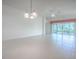 Bright and airy living room with tile flooring, ceiling fan, and large sliding glass doors at 1741 Pennecamp Dr, The Villages, FL 32162