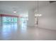 Bright living room with tile floors, white walls, sliding glass doors and views to other rooms at 1741 Pennecamp Dr, The Villages, FL 32162