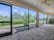 Screened in patio with tile flooring and view of landscaped backyard at 1741 Pennecamp Dr, The Villages, FL 32162