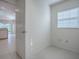 A room with neutral walls and tile flooring, with a window at 1741 Pennecamp Dr, The Villages, FL 32162