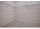 Walk-in closet features wire shelving and neutral carpet at 1741 Pennecamp Dr, The Villages, FL 32162
