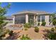 Well-maintained backyard with rock garden, patio, screened-in lanai, and attractive landscaping at 1796 Zientara Loop, The Villages, FL 32163