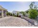 Paver patio in backyard with well-manicured landscaping and partial privacy fence at 1796 Zientara Loop, The Villages, FL 32163