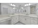 A bright bathroom boasts dual sinks, modern vanities, and ample counter space at 1796 Zientara Loop, The Villages, FL 32163